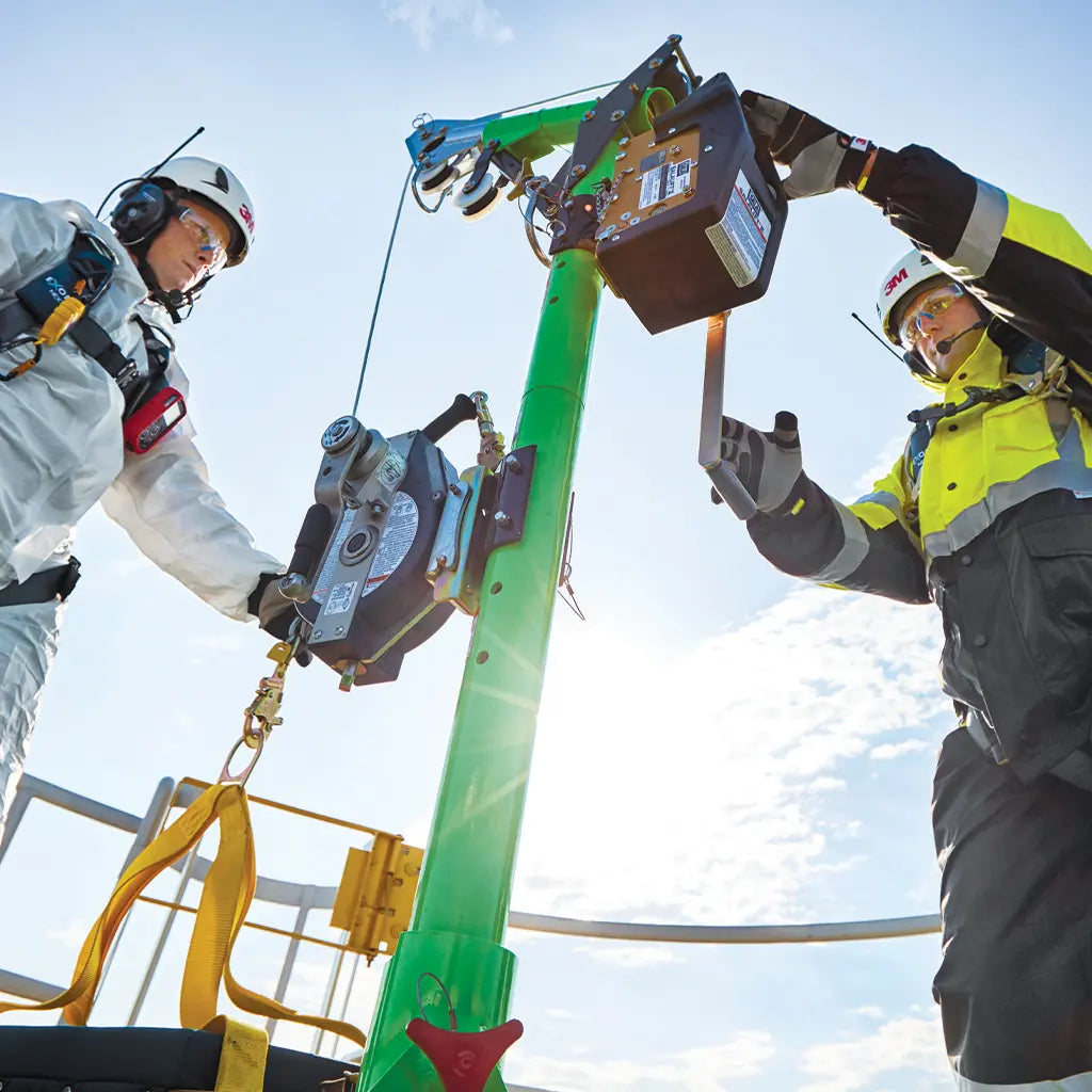 Workers using 3M confined space rescue equipment